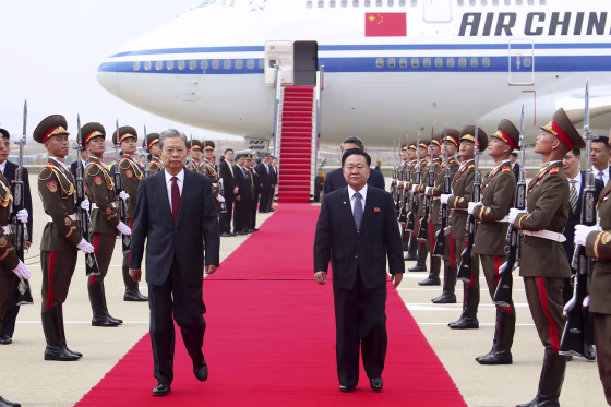 Choe Ryong Hae, center right, and Zhao Leji, center left, at the Pyongyang International Airport in Pyongyang, North Korea