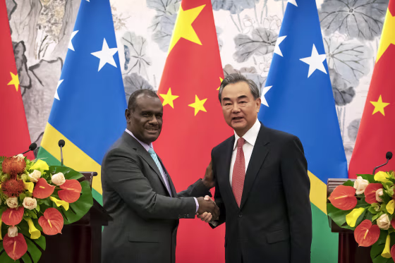 Jeremiah Manele, First Minister of the Solomon Islands, pictured with Chinese Foreign Minister Wang Yi in 2019.