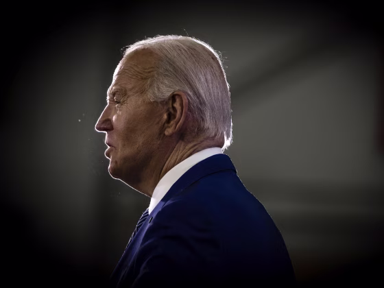 President Joe Biden against a dark background.