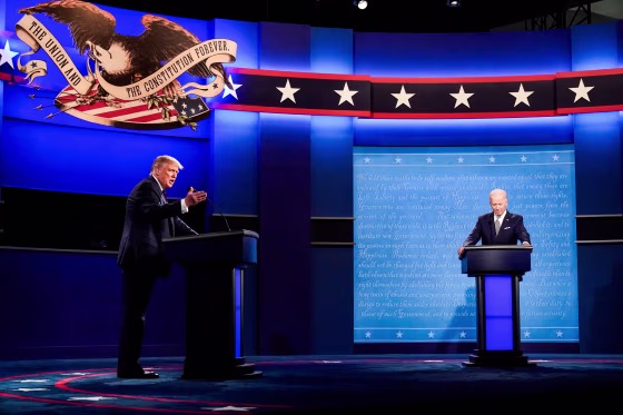 Donald Trump and Joe Biden debate on stage at their podiums
