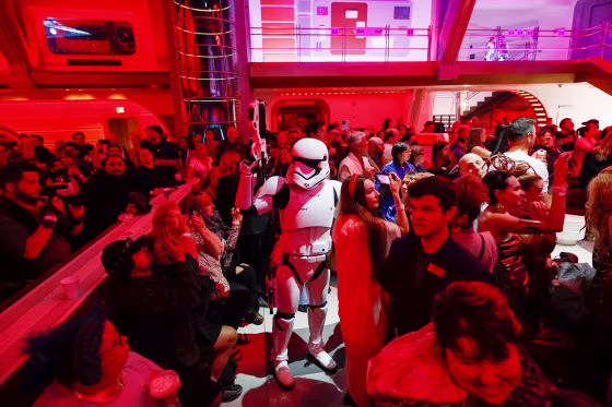 A First Order Stormtrooper patrols through the crowd