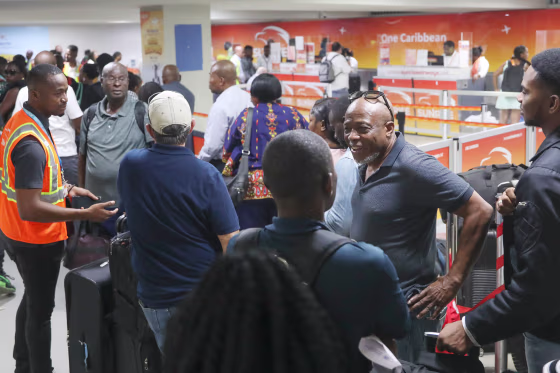 Passengers speaks while standing  in line