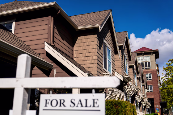 A "For Sale" sign in front of a home.