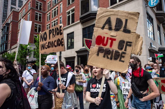 Protesters hold signs