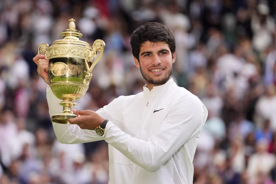 Spain's Carlos Alcaraz holds up the winner's trophy at Wimbledon