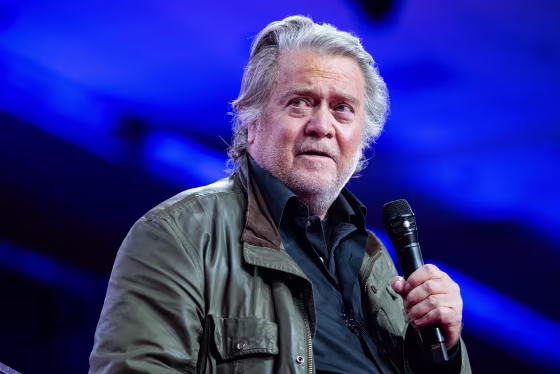 Steve Bannon speaks, holding a microphone