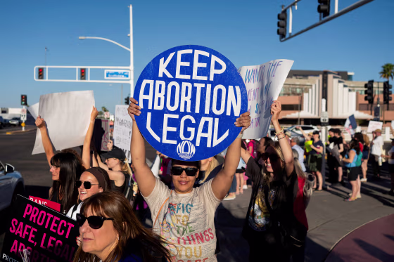 A protester holds a sign that reads "Keep Abortion Legal"