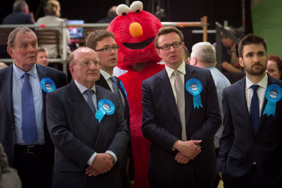 Elmo stands behind conservative supporters during the U.K. general election in 2015.