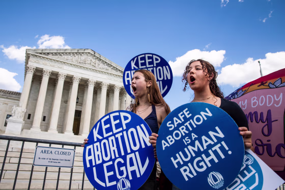 Reproductive Rights Advocates Protest At The US Supreme Court, holding signs that say "Keep Abortion Legal" and "Safe Abortion is a human right!"