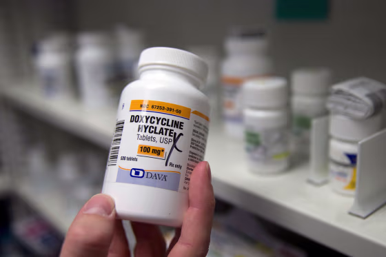 A pharmacist holds a bottle of the antibiotic doxycycline hyclate in Sacramento, Calif.