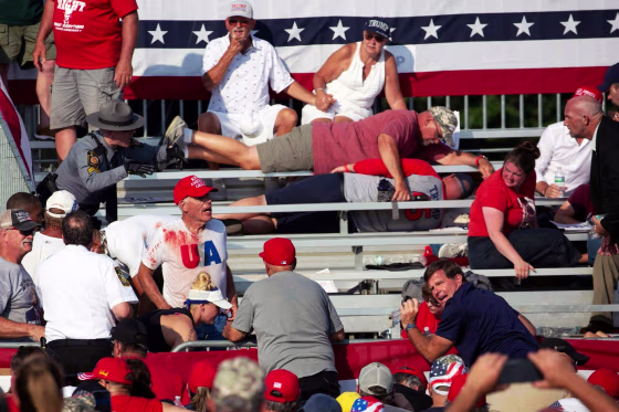 Attendees some covered in blood lie in the stands