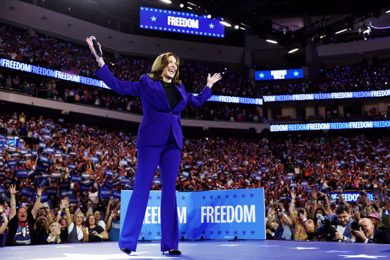 Kamala Harris holds her hands up after walking onstage