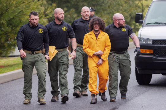 Pennsylvania Department of Corrections officers escort Cavalcante in handcuffs