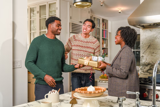 three people exchanging gifts with their brother in law