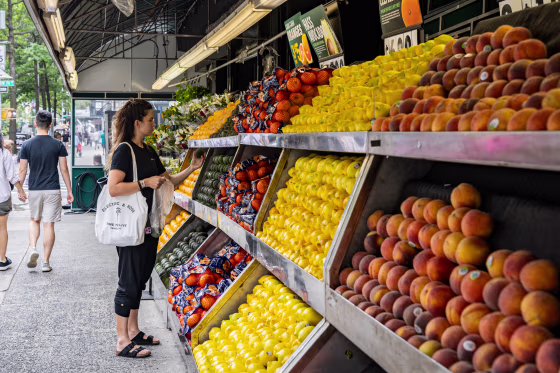 A person buys produce.
