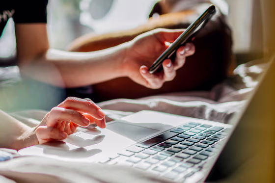 A person uses her phone to log into computer.