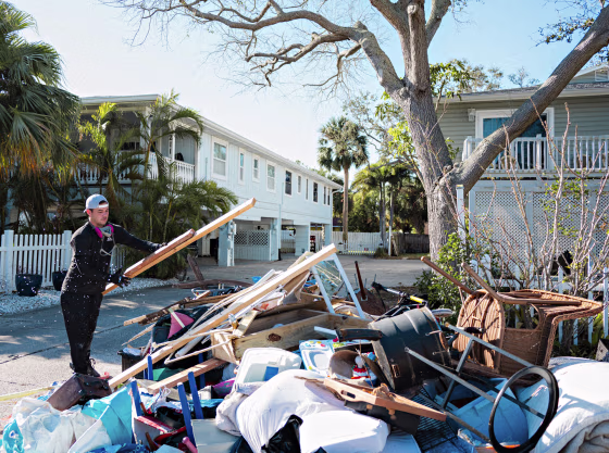 A construction worker removes a bathroom that was damaged in Hurricane Helene in Indian Rocks Beach, Fla., on Oct. 18, 2024.