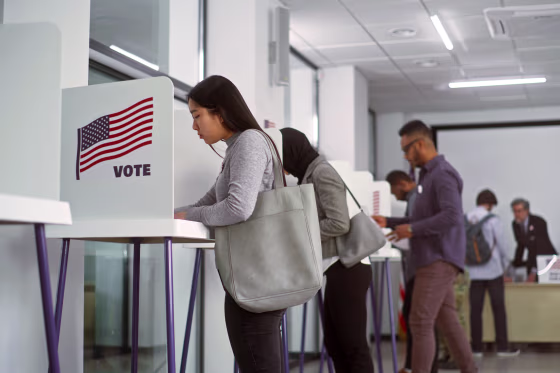 Asian woman voting booths in polling station office