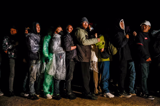 Chinese migrants stand in line
