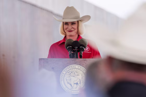 Dawn Buckingham smiles at a podium outdoors