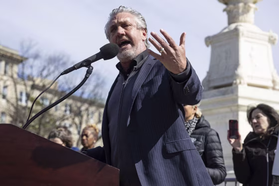 Anti-vaccine activist Del Bigtree speaks at a rally outside the Supreme Court 