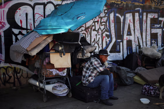 A man sits on a street in Skid Row, Los Angeles