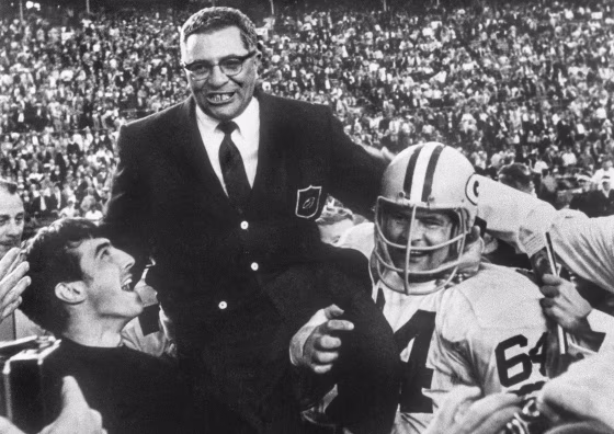 Green Bay Packers head coach Vince Lombardi is carried off the field by guard Jerry Kramer