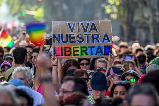 A person holds a sign that says "long live our freedom."