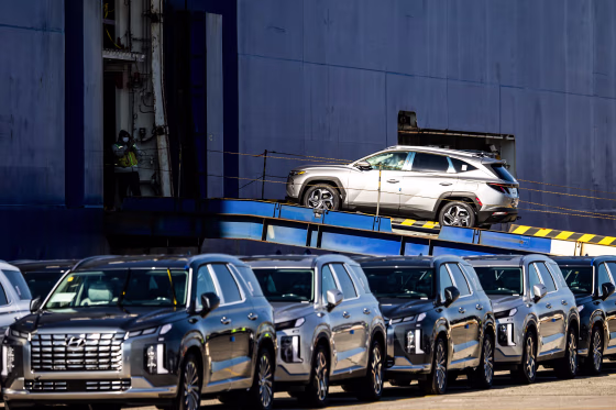 A Hyundai Motor Co. SUV bound for export is driven into a cargo ship