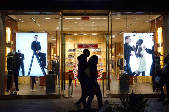 Shoppers pass a store at a mall in San Diego.