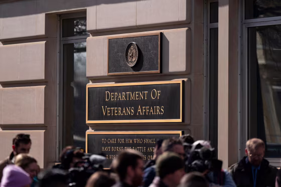 Members of the media cover a rally outside the Department of Veterans Affairs headquarters in Washington on Feb. 13, 2025.
