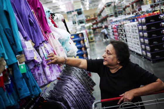 A customer browses a rack of clothes