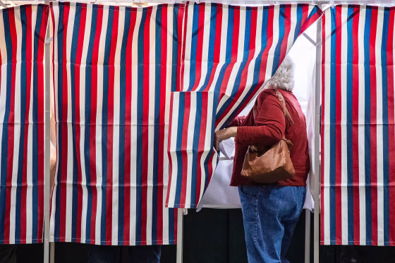 A voter enters a booth on Nov. 5, 2024, in Colebrook, N.H.