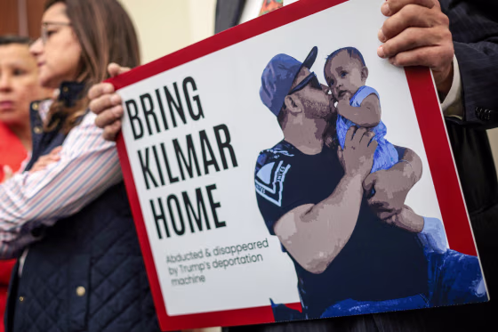 A member of the Congressional Hispanic Caucus holds a picture of Kilmar Abrego Garcia.