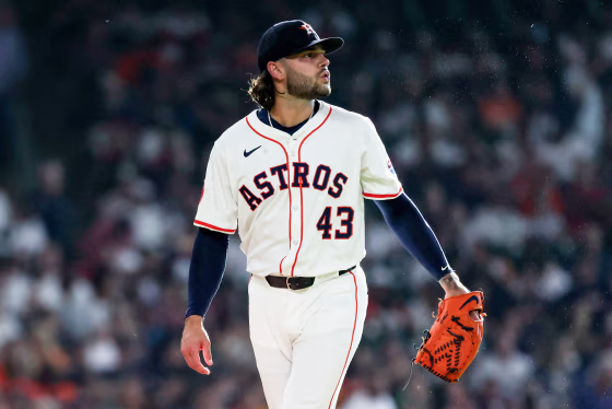Lance McCullers Jr walks on the baseball field, with a mitt on one hand