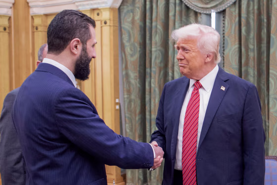 Donald Trump shakes hands with Syria's interim president Ahmed al-Sharaa