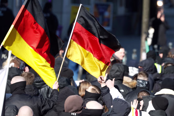 People wave German flags as they attend a march of extreme right supporters 
