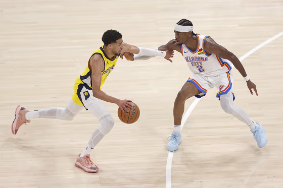 Tyrese Haliburton of the Indiana Pacers dribbles the ball as Shai Gilgeous-Alexander of the Oklahoma City Thunder plays defense
