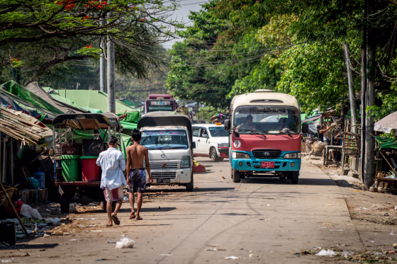 People walk down a rural road.