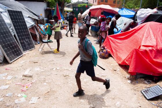 Image: A child leaves for school from a displaced persons camp