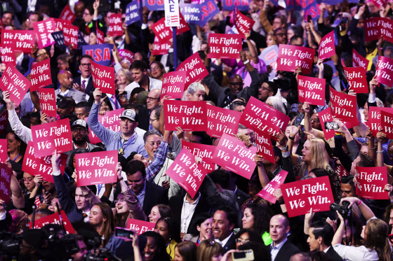 Democrats hold "We Fight, We Win" signs during the DNC