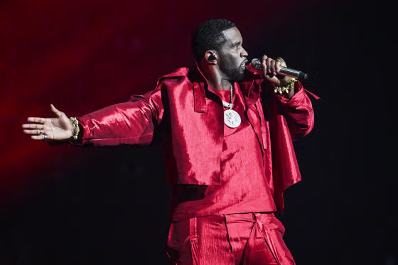 Sean "Diddy" Combs performs on stage, wearing all red