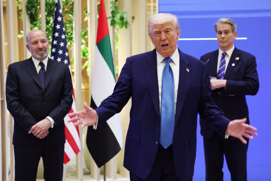 President Donald Trump speaking as Secretary of Commerce Howard Lutnick, left, and Secretary of the Treasury Scott Bessent stand next to him.