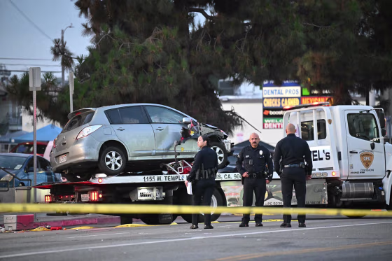 A vehicle is taken away on a truck after it drove into a crowd in Hollywood