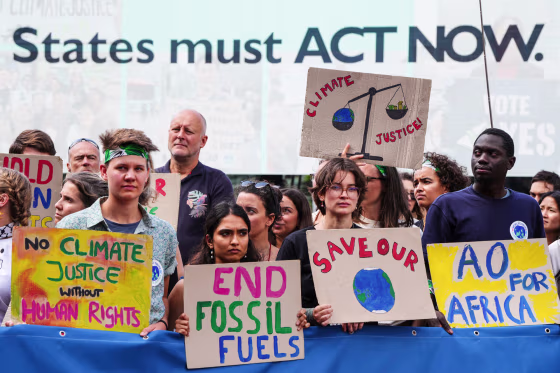 Climate activits hold signs outside