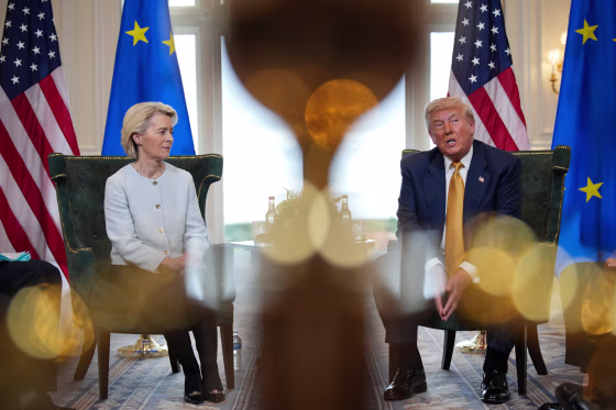 From left, Ursula von der Leyen, and Donald Trump sit inside of a room