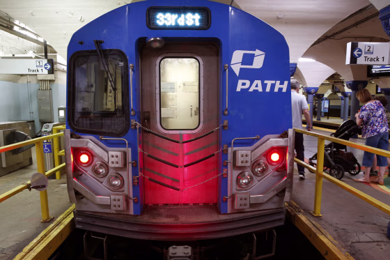 People board a PATH train.