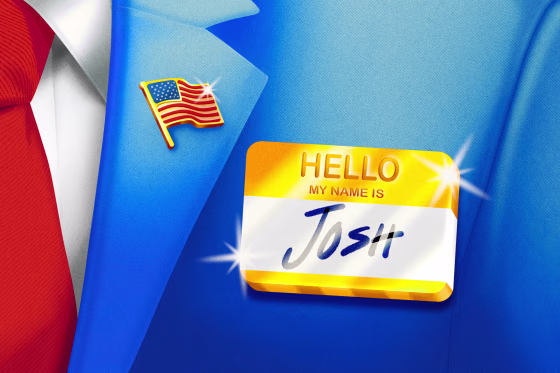 Close-up of suit with an American flag lapel pin and a golden "Hello My Name Is" tag with "JOSH" written on it.