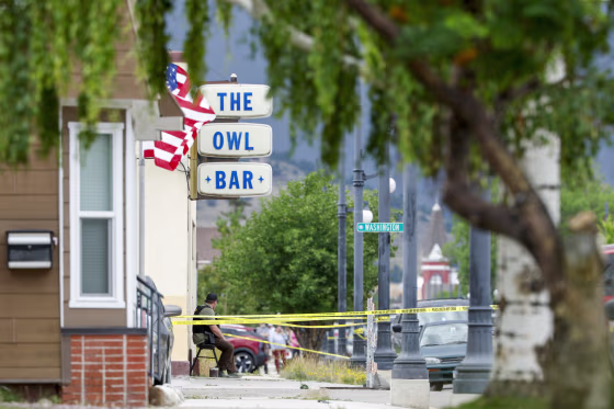 A view of the exterior of The Owl Bar, sidewalk covered with police tape