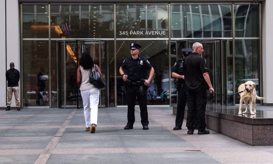 Image: People enter 345 Park Avenue as the building partially reopens